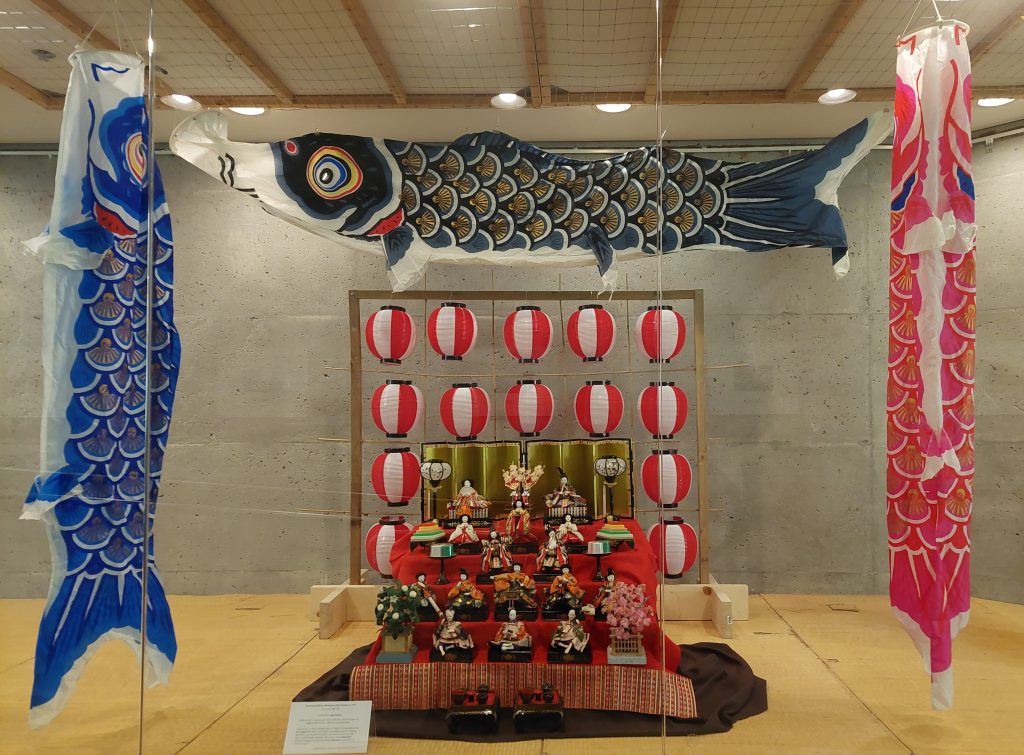 A display of three carp streamers (koinobori), doll set (hina ningyō)  and Japanese lanterns.